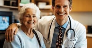 Doctor smiling with elderly patient in office.